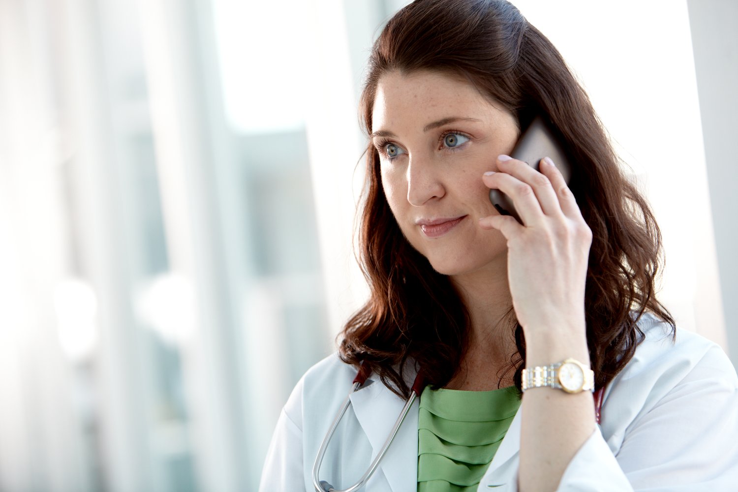 A doctor is on the telephone 
