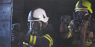 Firefighter using thermal imaging camera
