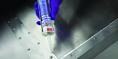 Technician seals a corner with a metal to metal adhesive
