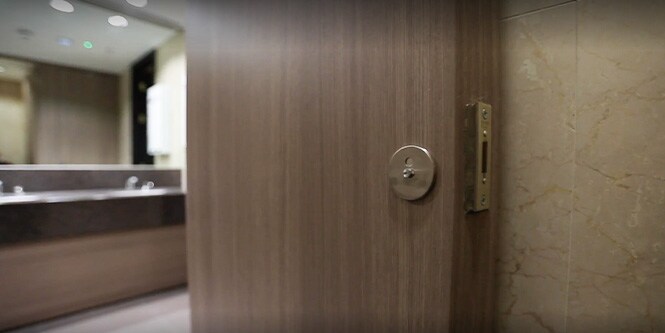 Video thumbnail of door to refurbished restroom area covered with dark wood-toned 3M DI-NOC Architectural Finishes
