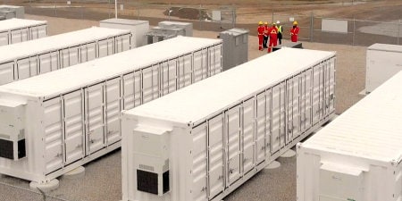 image of workers near battery array
