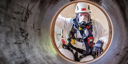 A worker wearing 3M respirator and helmet
