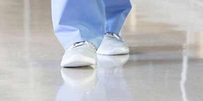 healthcare professional walking on a clean and disinfected hospital floor
