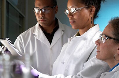 Scientists examining hazardous materials
