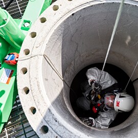 A worker wearing 3M helmet in a confined space